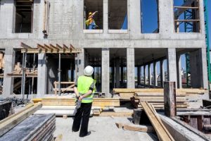 land surveyor working on commercial property with architects and engineers
