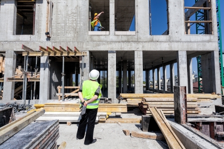 image of construction worker surveying a commercial construction site