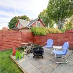 fenced back yard with patio area and barbecue grill. northwest, usa