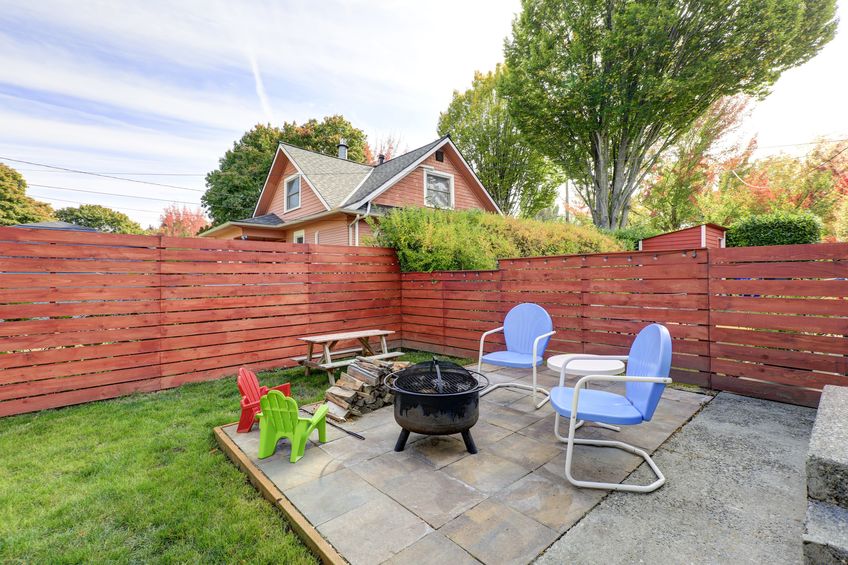 fenced back yard with patio area and barbecue grill. northwest, usa